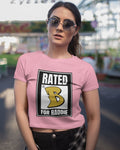 Woman wearing a pink t-shirt with a 'Rated B for Baddie' graphic design.