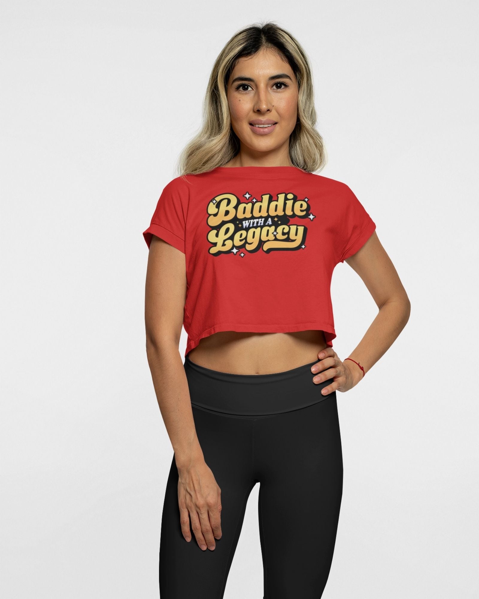 Woman wearing a red crop top with text and black leggings on a white background