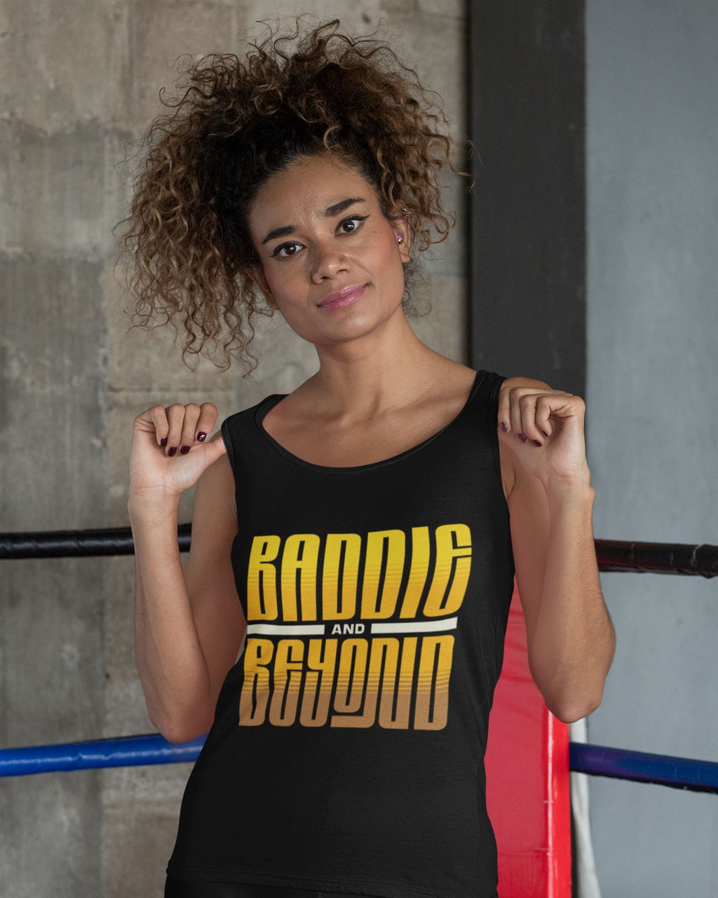 Woman wearing a black tank top with 'Randie and Beyond' text in a boxing ring.