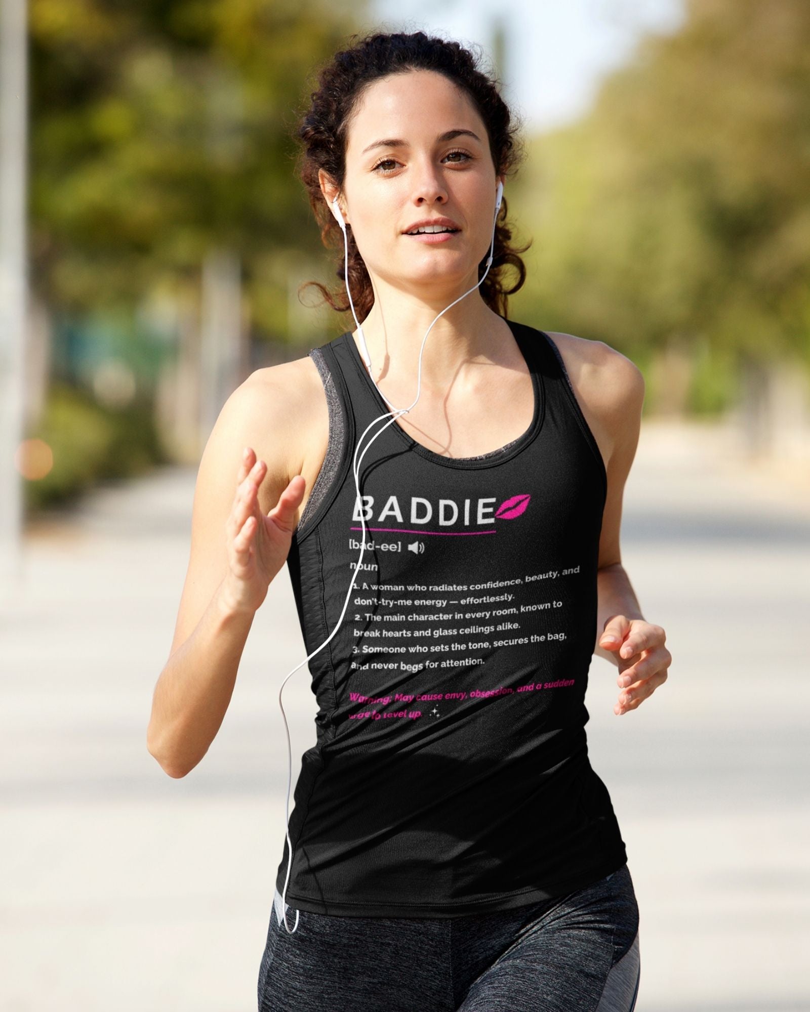 Woman running outdoors wearing a black tank top with text and a logo.