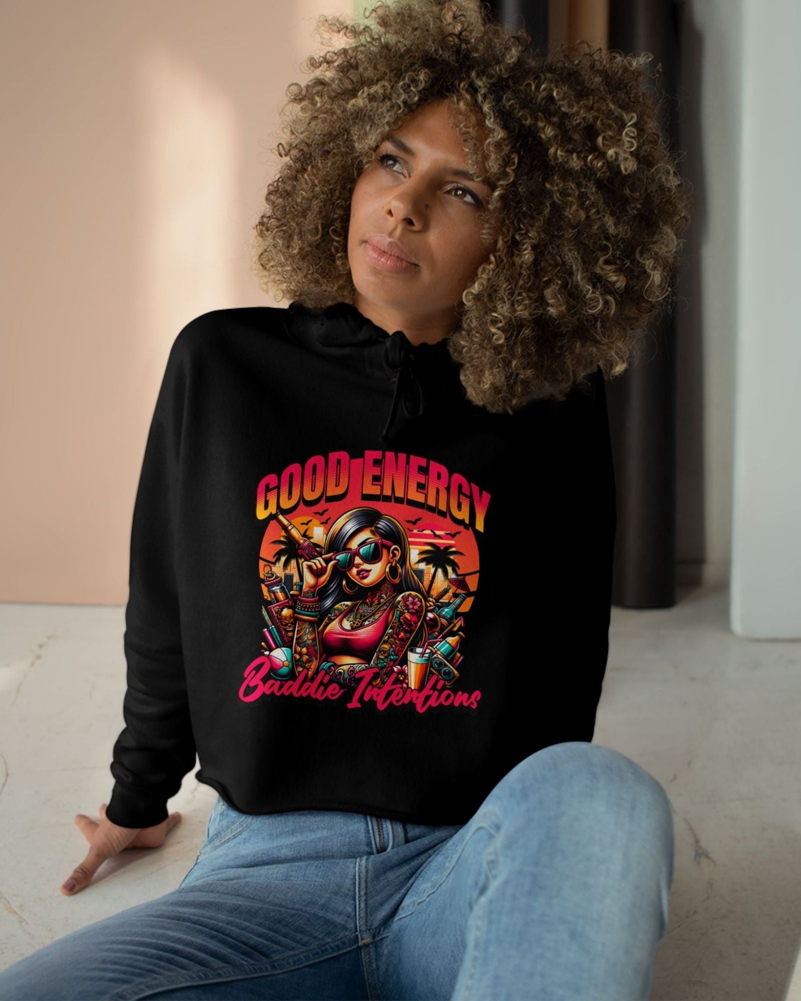 Woman wearing a black hoodie with colorful graphic design and text.